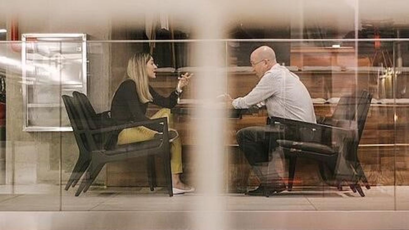 two people in a meeting room talking