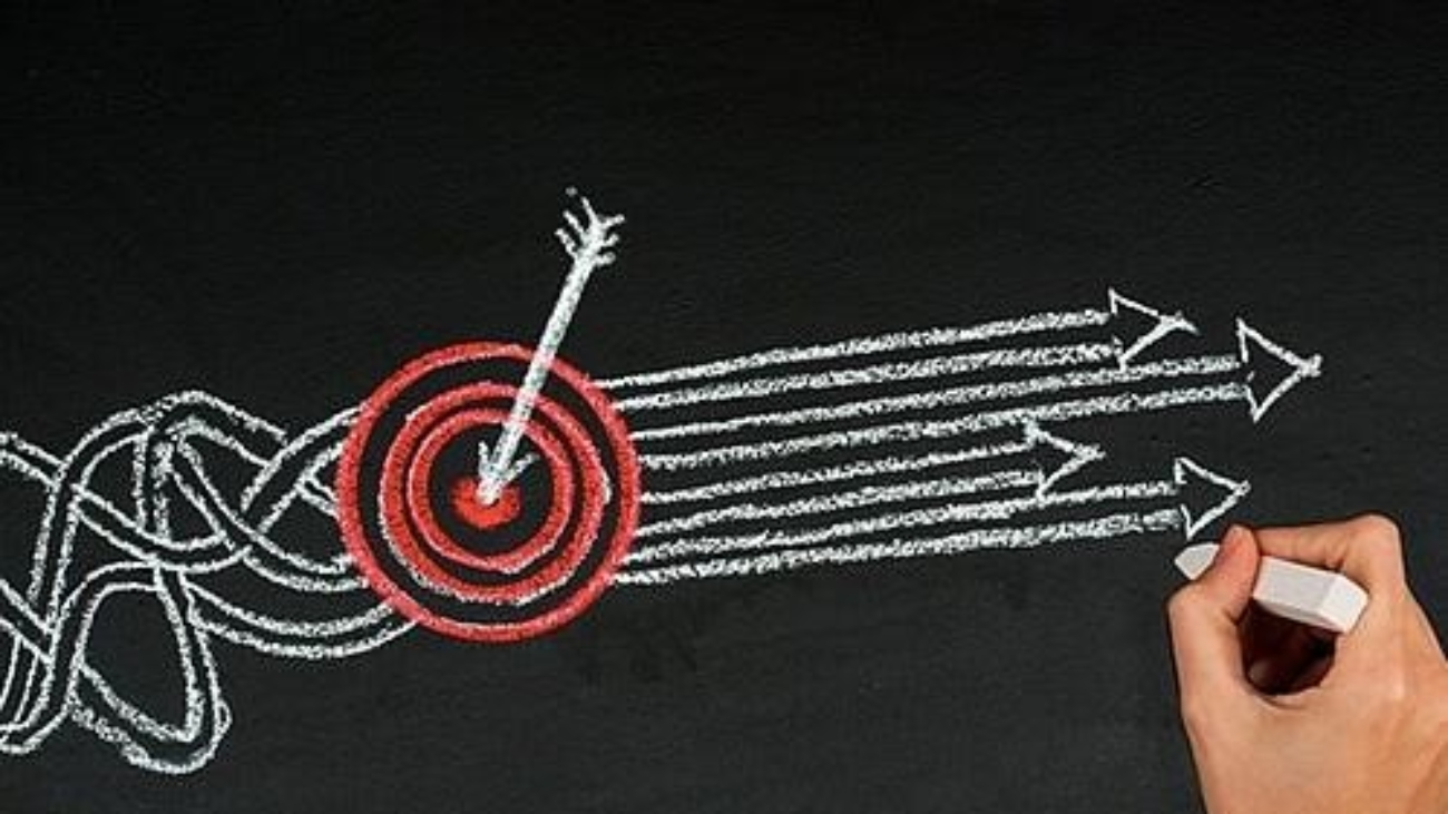 a target and arrows drawn on a blackboard