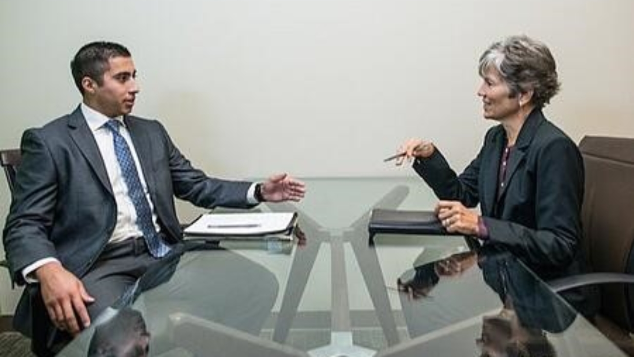 two people discussing business at a table