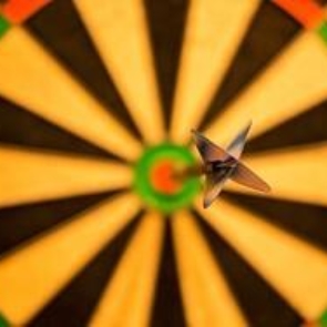 a dart in the bullseye of a dartboard